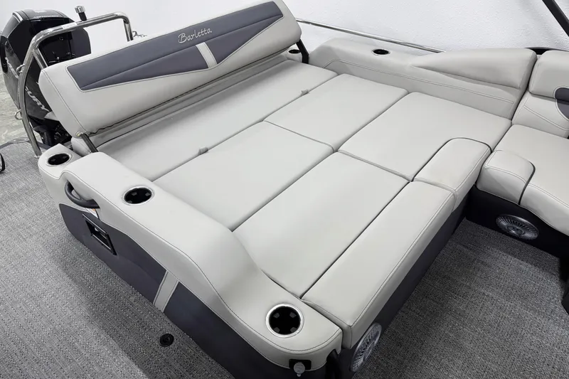 Slide: The Image of 2025 Barletta Cabrio 24U boat interior with spacious, luxurious seating and cup holders. - 10
