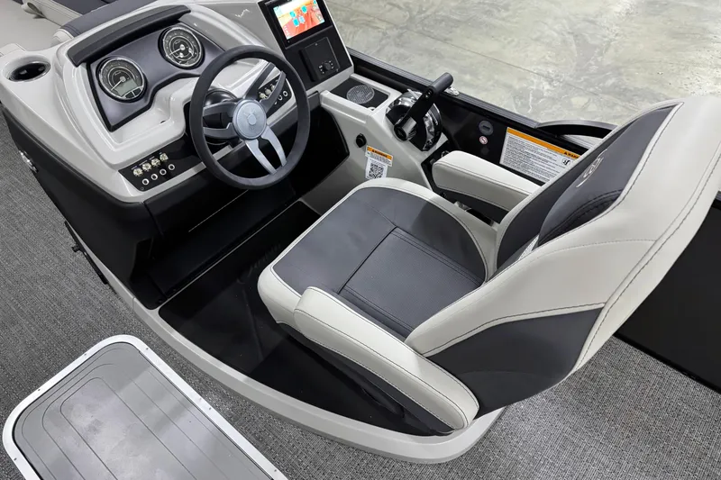 Slide: The Image of 2025 Barletta Cabrio 24U boat cockpit with steering wheel and modern dashboard. - 17