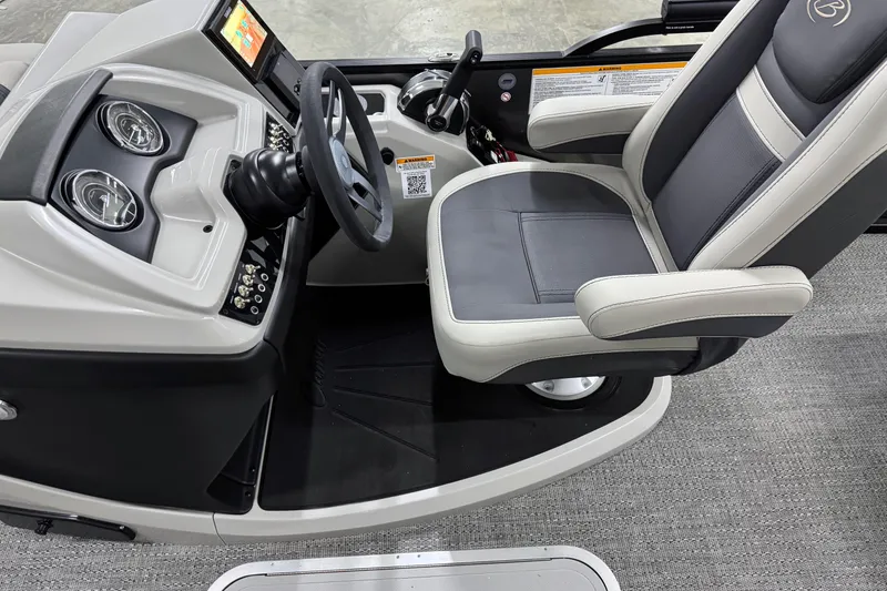 Slide: The Image of 2025 Barletta Cabrio 24U boat cockpit with steering wheel and captain's chair. - 18