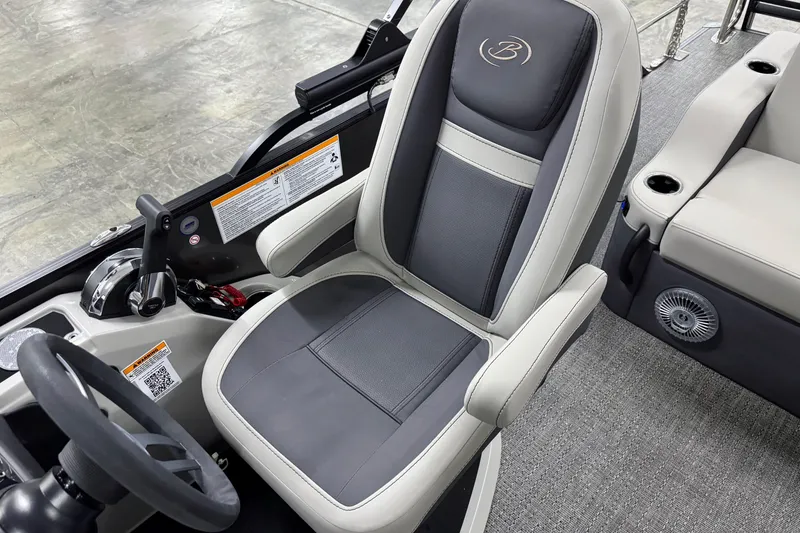 Slide: The Image of Captain's seat of 2025 Barletta Cabrio 24U pontoon boat, featuring sleek design and controls. - 19