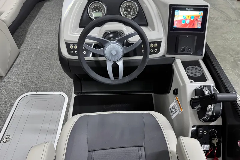 Slide: The Image of 2025 Barletta Cabrio 24U boat dashboard with steering wheel and digital display. - 20