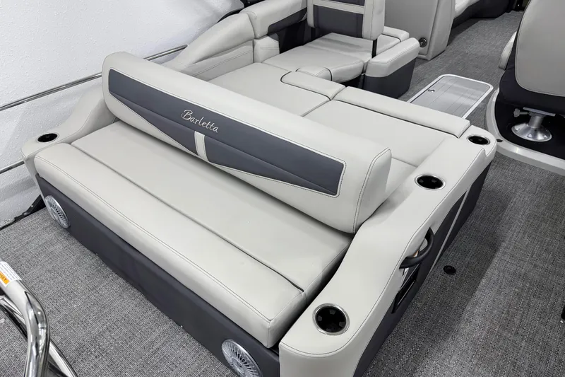 Slide: The Image of 2025 Barletta Cabrio 24U boat interior with luxurious seating and cup holders. - 3