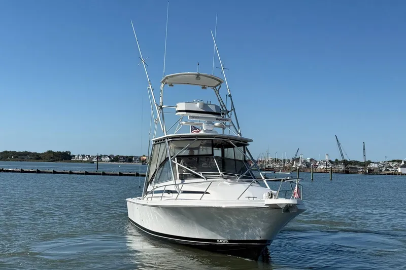 Slide: The Image of 1997 Blackfin Combi 33 boat on calm water, clear sky background. - 2