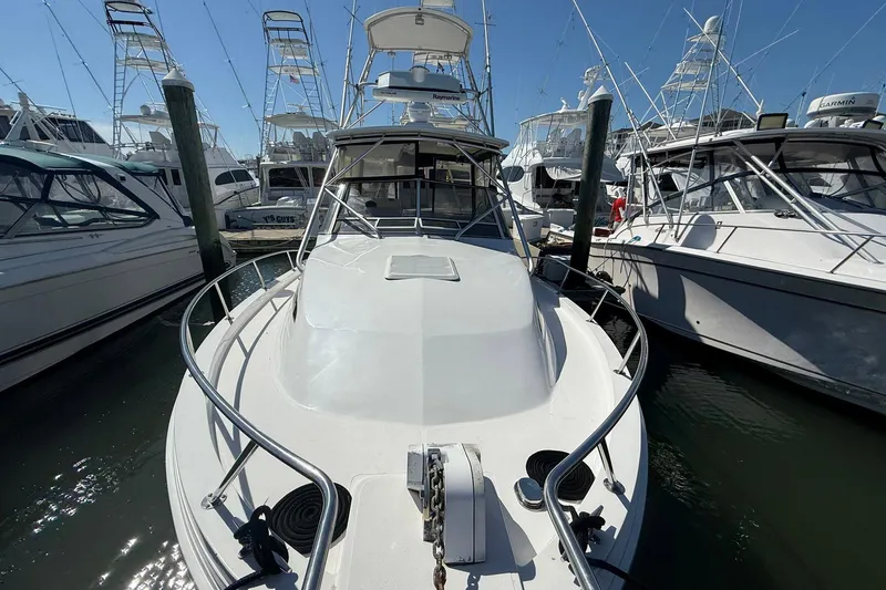 Slide: The Image of 1997 Blackfin Combi 33 boat docked among other vessels in a marina. - 21