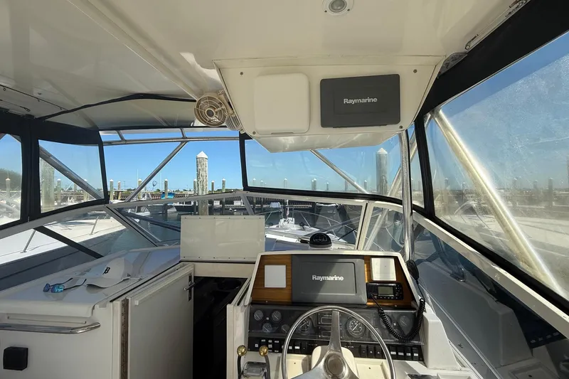 Slide: The Image of Interior view of 1997 Blackfin Combi 33 boat cockpit with Raymarine navigation system. - 22