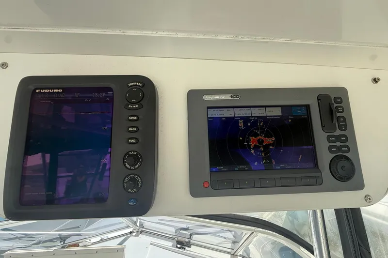 Slide: The Image of Navigation equipment on a 1997 Blackfin Combi 33 boat dashboard. - 25