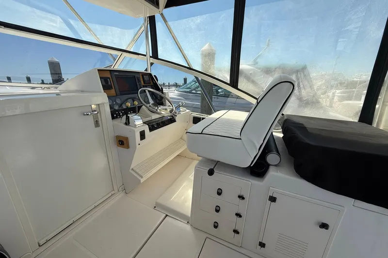 Slide: The Image of 1997 Blackfin Combi 33 boat helm with steering wheel and navigation controls. - 26