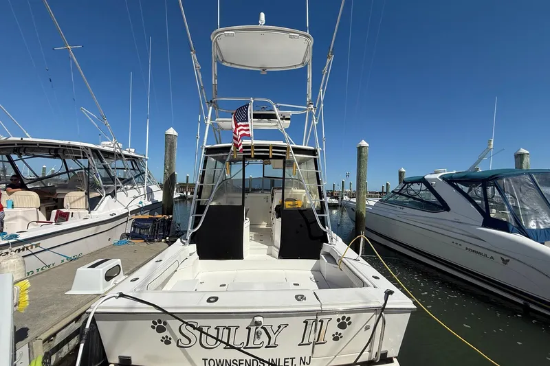 Slide: The Image of 1997 Blackfin Combi 33 boat docked, displaying American flag, named "Sully II" in Townsend's Inlet, NJ. - 33