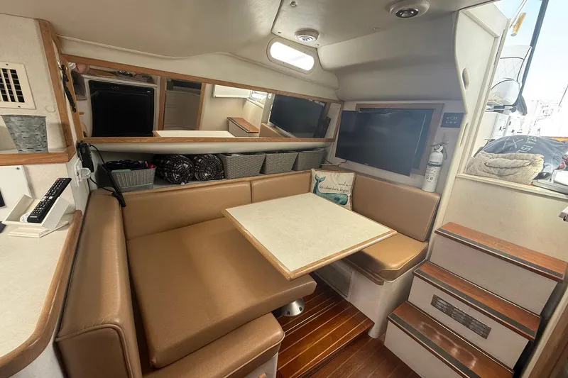 Slide: The Image of 1997 Blackfin Combi 33 interior with cozy seating, table, and modern amenities. - 7