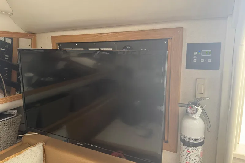 Slide: The Image of Interior of 1997 Blackfin Combi 33 with TV, control panel, and fire extinguisher. - 8