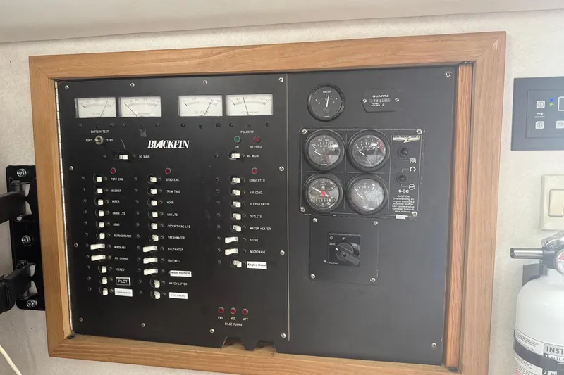 Slide: The Image of Electrical control panel of a 1997 Blackfin Combi 33 boat with gauges and switches. - 9