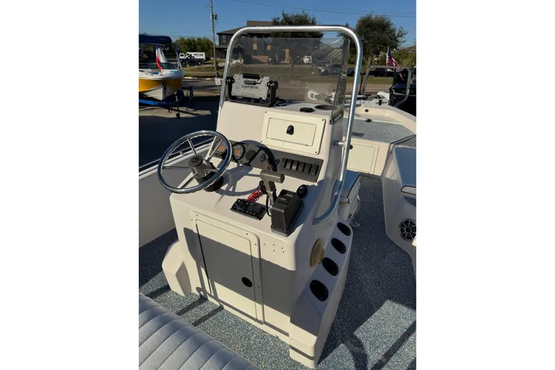 Slide: The Image of 2001 Pathfinder 2200 V boat console with steering wheel and controls. - 11