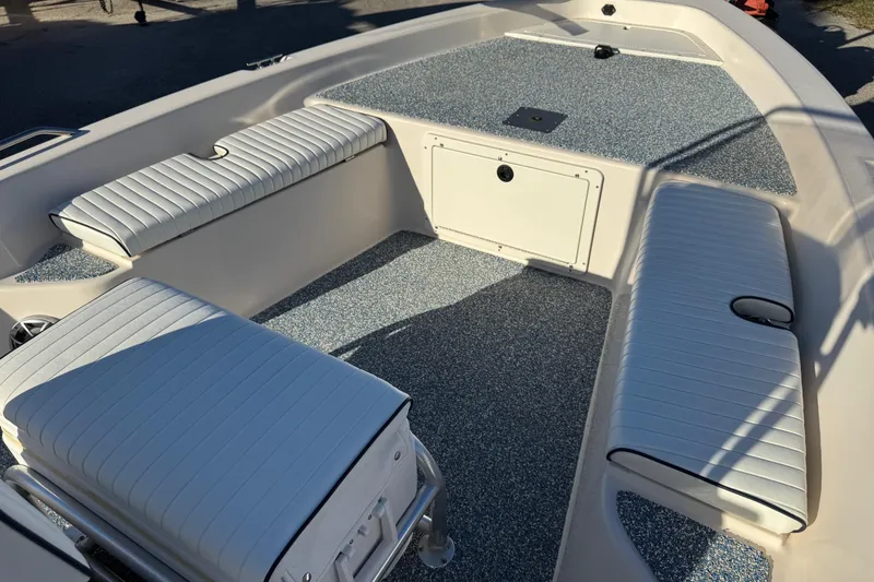 Slide: The Image of 2001 Pathfinder 2200 V boat interior with cushioned seating and textured flooring. - 12
