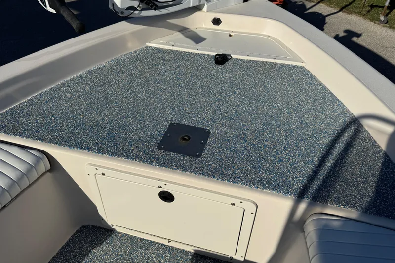 Slide: The Image of 2001 Pathfinder 2200 V boat deck with textured surface and storage compartment. - 13