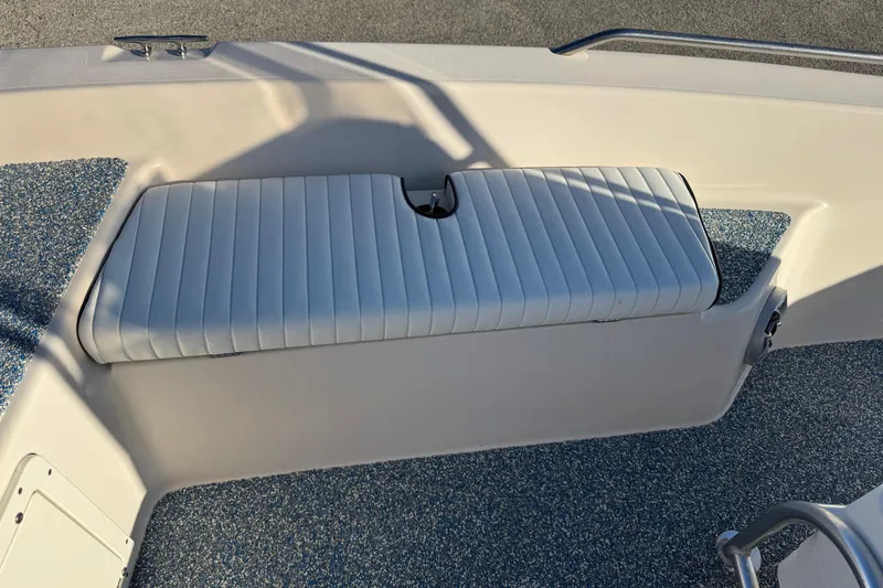Slide: The Image of 2001 Pathfinder 2200 V boat interior with cushioned seating and textured flooring. - 15