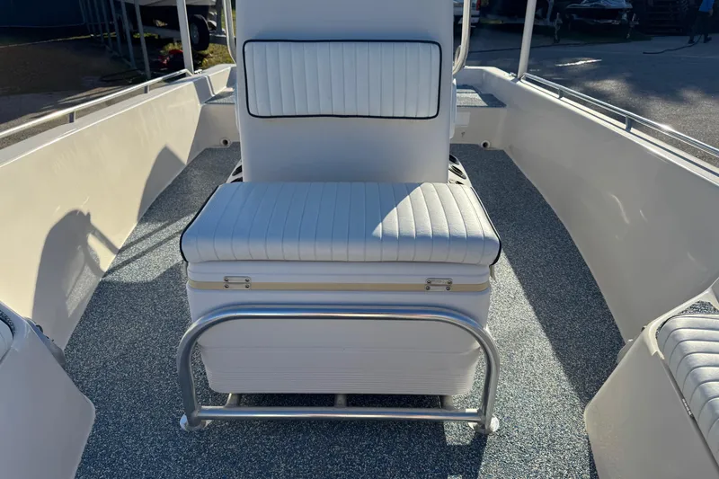 Slide: The Image of 2001 Pathfinder 2200 V boat interior with white cushioned seating and textured flooring. - 16