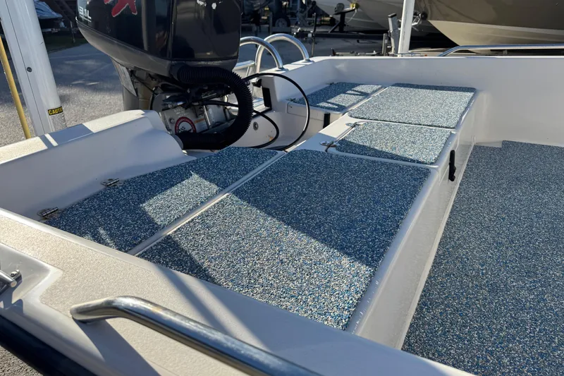 Slide: The Image of 2001 Pathfinder 2200 V boat interior with textured flooring and outboard motor. - 4
