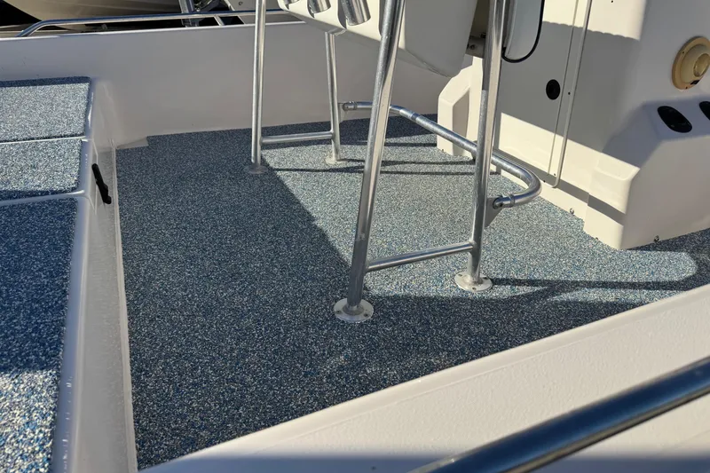 Slide: The Image of 2001 Pathfinder 2200 V boat deck with textured flooring and metal railings. - 5