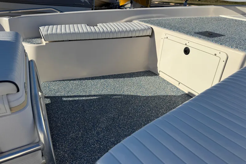 Slide: The Image of 2001 Pathfinder 2200 V boat interior with white seating and textured flooring. - 6