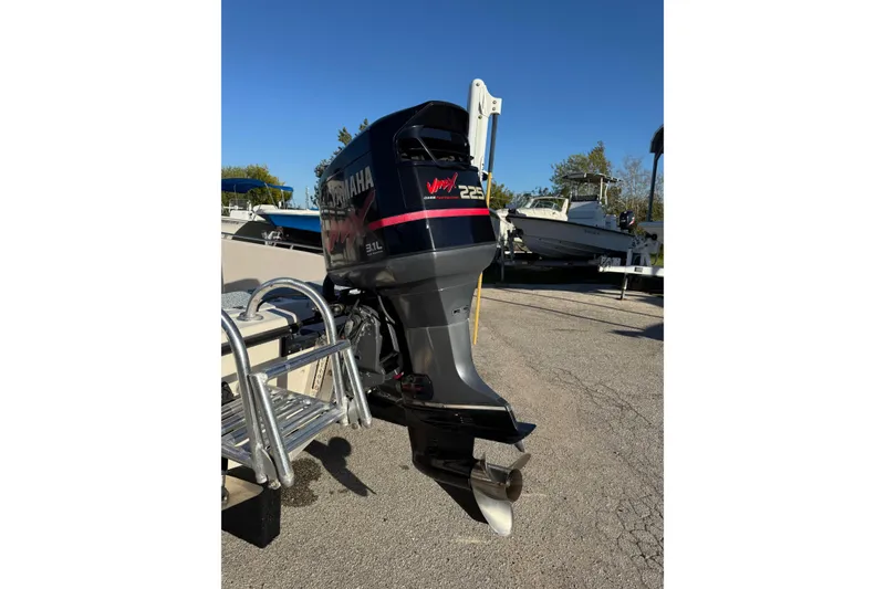 Slide: The Image of 2001 Pathfinder 2200 V boat with Yamaha outboard motor in a sunny marina. - 8