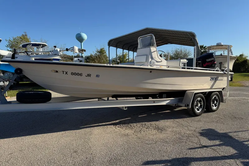 Slide: The Image of 2001 Pathfinder 2200 V boat on trailer, parked outdoors under clear sky. - 9