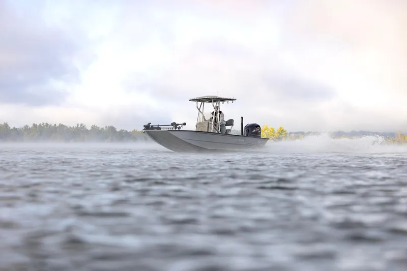 Slide: The Image of 2026 G3 Bay 22 GX boat cruising on misty water with scenic background. - 3