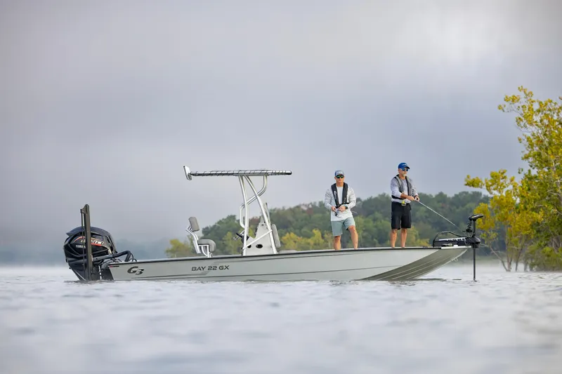 Slide: The Image of Two people fishing on a 2026 G3 Bay 22 GX boat in a serene lake. - 4