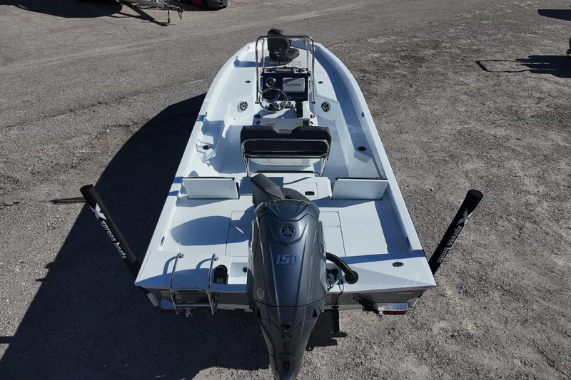 Slide: The Image of 2026 Xpress H22B Bay boat with Yamaha 150 engine, parked on gravel. - 12
