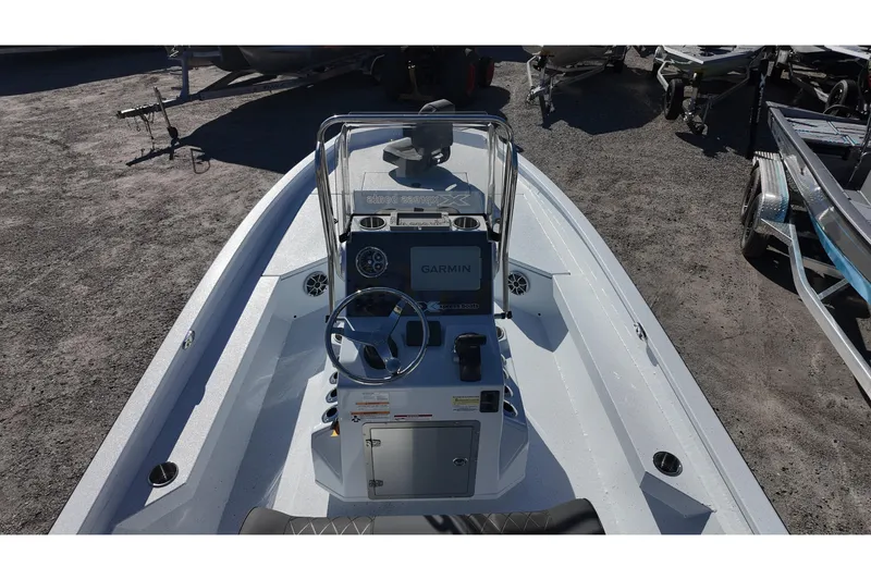Slide: The Image of 2026 Xpress H22B Bay boat interior with Garmin navigation system, steering wheel, and console. - 13