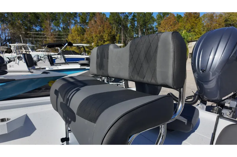Slide: The Image of 2026 Xpress H22B Bay boat with sleek seating and powerful engine in marina setting. - 15