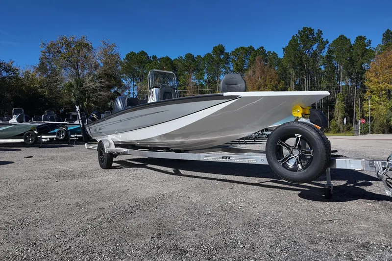 Slide: The Image of 2026 Xpress H22B Bay boat on trailer, parked outdoors with trees in background. - 3