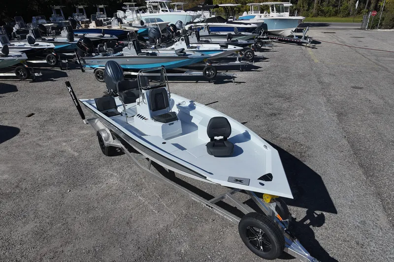 Slide: The Image of 2026 Xpress H22B Bay boat on trailer, surrounded by other boats in a lot. - 4