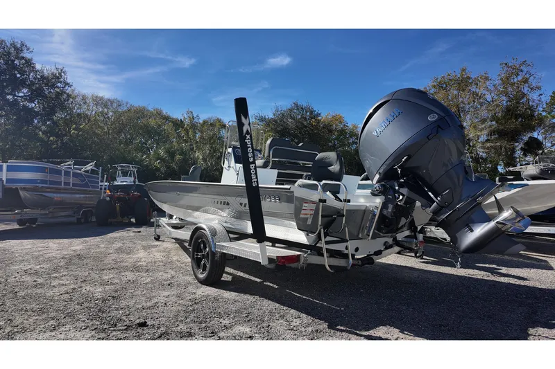Slide: The Image of 2026 Xpress H22B Bay boat with Yamaha engine on trailer, parked outdoors. - 5