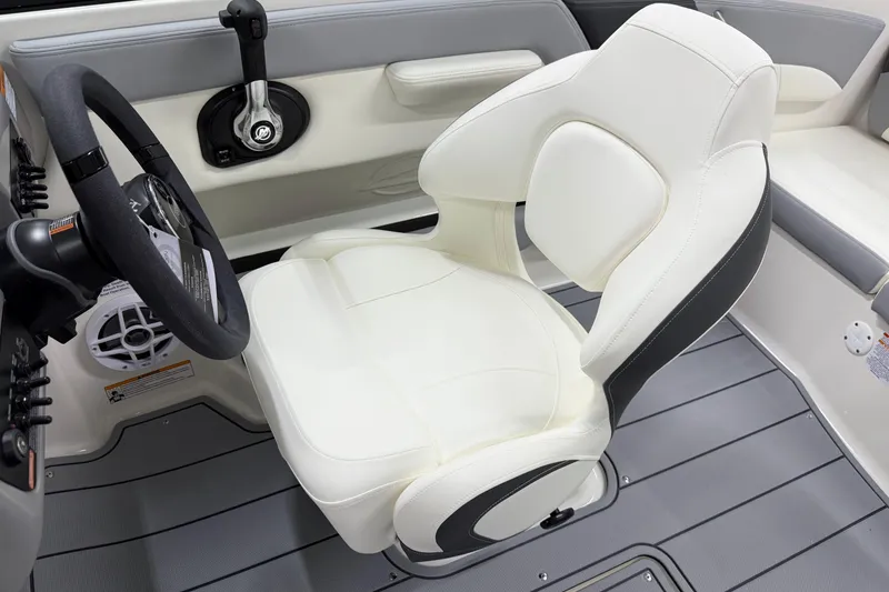 Slide: The Image of 2025 Chaparral 21 SSi boat interior with white captain's seat and steering wheel. - 10