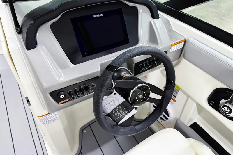 Slide: The Image of 2025 Chaparral 21 SSi boat dashboard with steering wheel and control panel. - 12