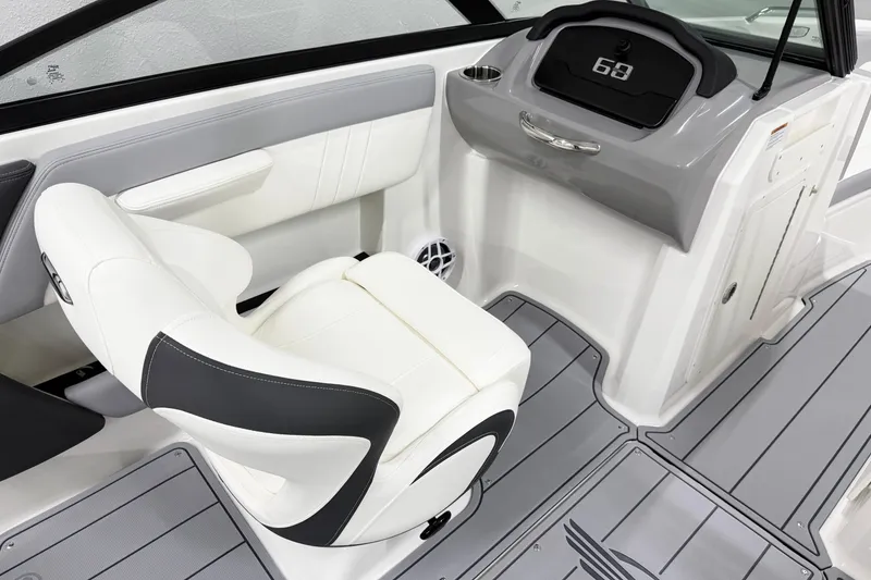 Slide: The Image of Interior of 2025 Chaparral 21 SSi boat, featuring sleek white seating and modern dashboard. - 13