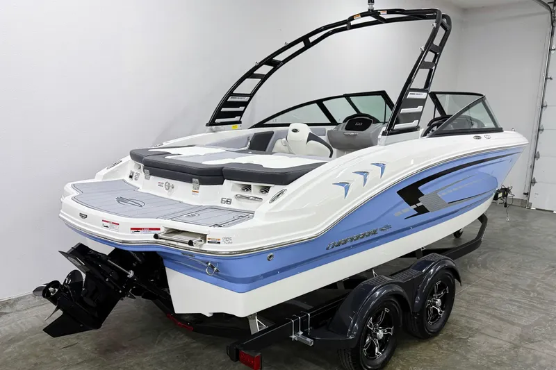 Slide: The Image of 2025 Chaparral 21 SSi boat with sleek design and modern features in showroom. - 2