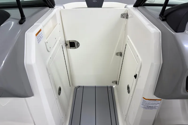 Slide: The Image of 2025 Chaparral 21 SSi boat interior with storage compartments and sleek design. - 21