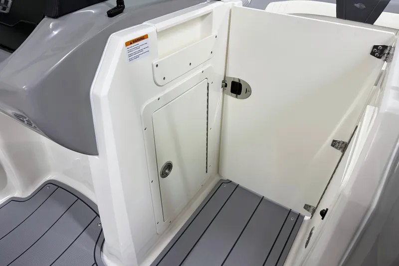 Slide: The Image of 2025 Chaparral 21 SSi boat interior with open storage compartment and sleek design. - 23