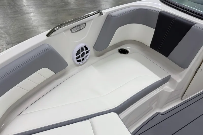 Slide: The Image of 2025 Chaparral 21 SSi boat interior with gray and white seating, speaker, and cup holder. - 27