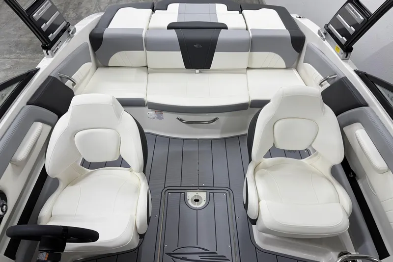 Slide: The Image of 2025 Chaparral 21 SSi boat interior with white and gray seating, modern design. - 7
