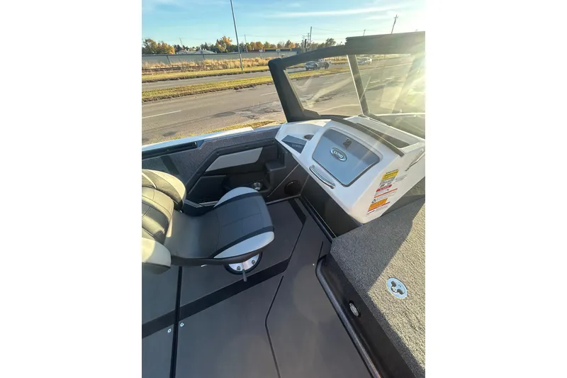 Slide: The Image of 2026 Lund 202 Pro-V GL boat interior with steering console and seating. - 18