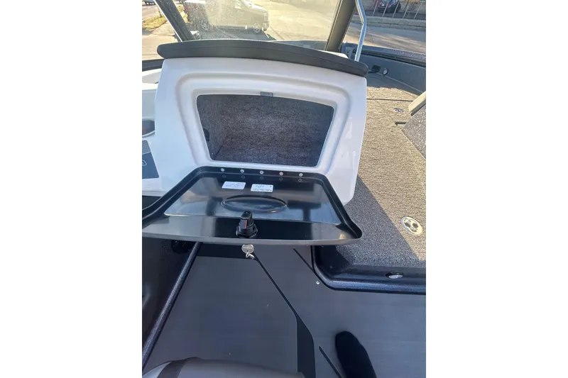 Slide: The Image of 2026 Lund 202 Pro-V GL boat interior storage compartment with open hatch. - 19