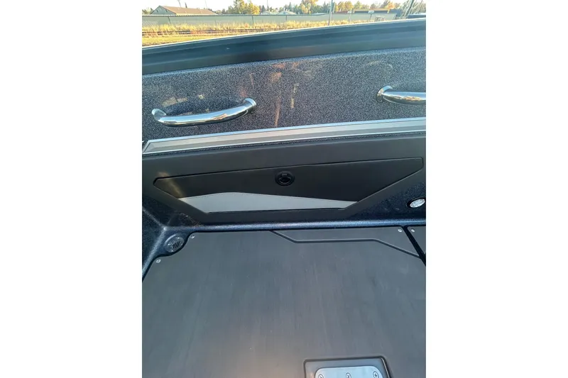 Slide: The Image of 2026 Lund 202 Pro-V GL boat interior with sleek design and metallic handles. - 26