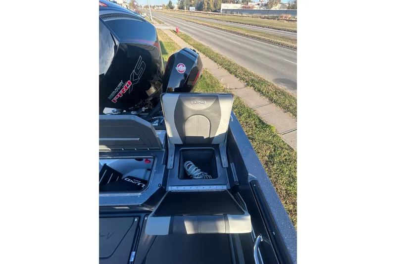 Slide: The Image of 2026 Lund 202 Pro-V GL boat with storage compartments and Mercury Pro XS engine. - 27