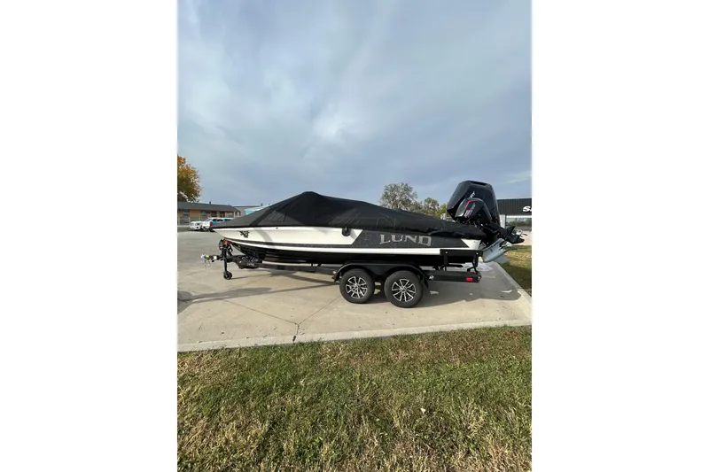 Slide: The Image of 2026 Lund 219 Pro-V GL boat on trailer under blue sky. - 11