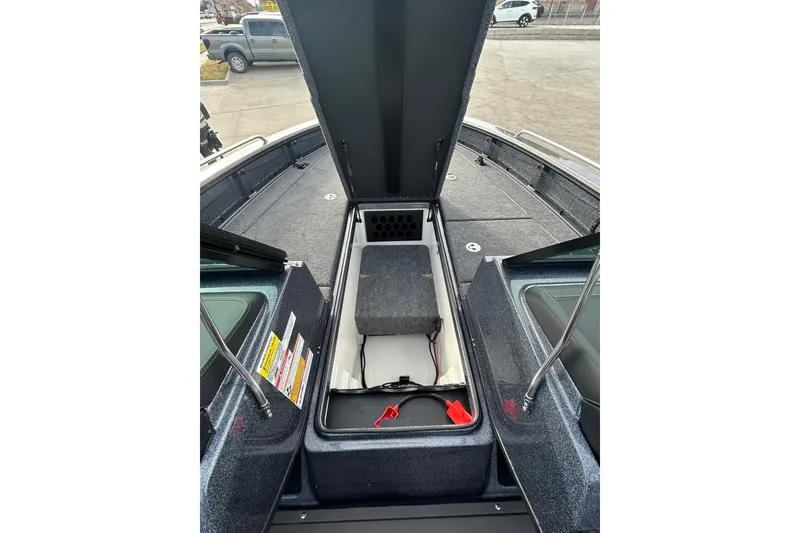 Slide: The Image of 2026 Lund 219 Pro-V GL boat on trailer, covered, parked outdoors. - 21