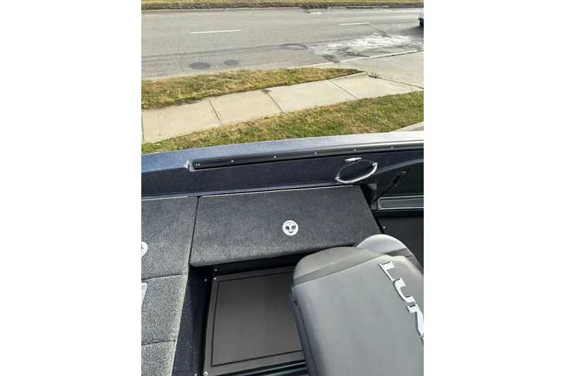 Slide: The Image of 2026 Lund 219 Pro-V GL boat dashboard with steering wheel and gauges. - 27