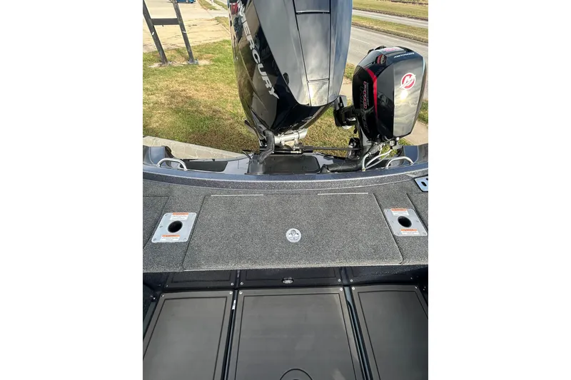 Slide: The Image of 2026 Lund 219 Pro-V GL boat interior with steering wheel and seating. - 28