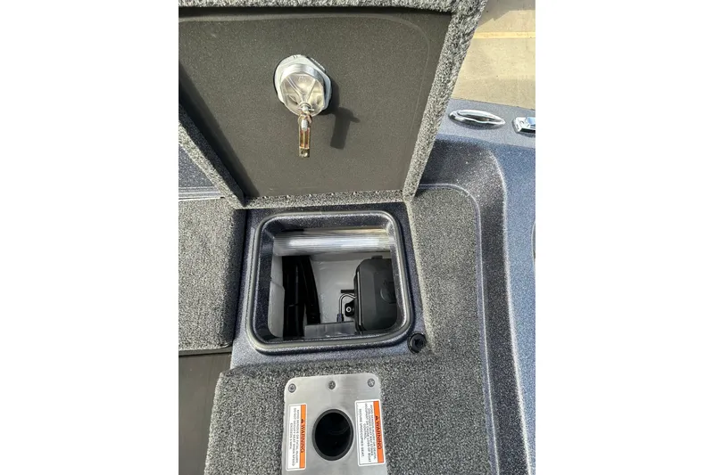 Slide: The Image of 2026 Lund 219 Pro-V GL boat deck with storage compartments and trailer. - 29